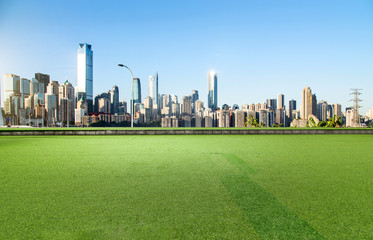 The square with lawn and the modern city skyline are in Chongqing, China.