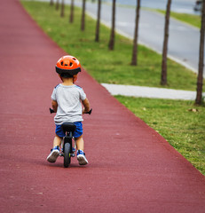 A Little Kid on his Bicycle in the Cycle Line of the Park City