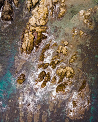 Aerial photo of waves on rocky coast