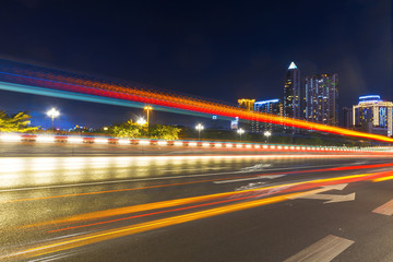 Fototapeta na wymiar abstract image of blur motion of cars on the city road at night，Modern urban architecture in Chongqing, China