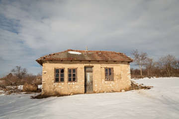 Old abandoned village house on winter