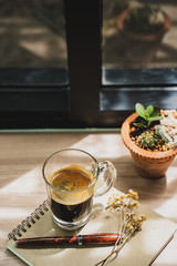A coffee and a book on wood desk setting in idea and chilling concept.