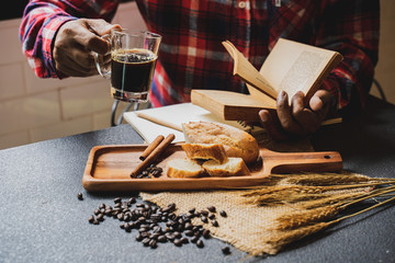 a coffee set on desk with people sit behind besie window.