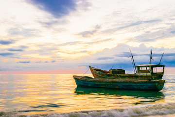 Old fishing boats floating near the coastline at sunset in Westmoreland, Jamaica