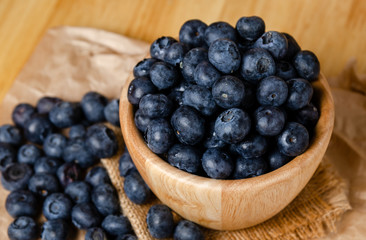 top view close up shot of blueberries in wooden bowl
