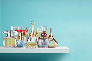 Aromatic Perfume bottles on wooden table on blurred background