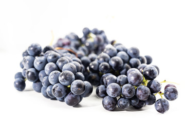 Raw dark grapes isolated on white background. Autumn abstractions.