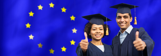 education, graduation, gesture and people concept - happy international graduate students in mortar...