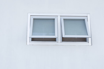small aluminum glass window on cement wall