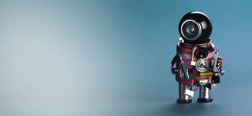 Robot mechanic handyman with screw drivers. Blue background, copy space