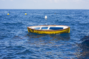 Small wooden boats at city river coats. Sunny day