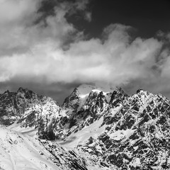 Black and white snowy rocks in clouds