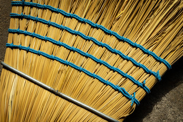 Closeup macro broom texture with natural tan and yellow fibers in high detail zoomed in.