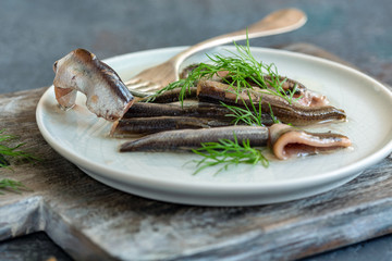 Anchovies in olive oil with fresh dill.