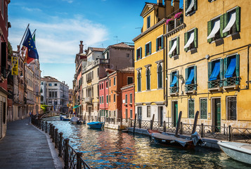 Traditional canal street and colorful Venetian houses in Venice, Italy.