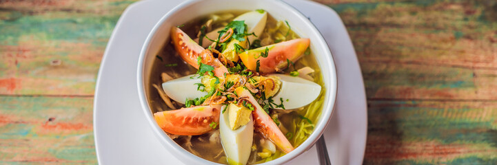 Soto is a traditional Indonesian soup mainly composed of broth, chicken and vegetables BANNER, long format