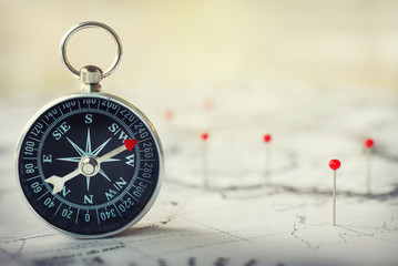 Magnetic compass on world map.Travel, geography, navigation, tourism and exploration concept...