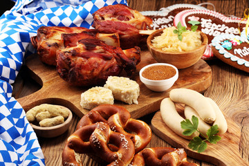 Traditional German cuisine, Schweinshaxe roasted ham hock. Beer, pretzels and various Bavarian specialties. Oktoberfest background