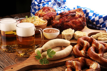 Traditional German cuisine, Schweinshaxe roasted ham hock. Beer, pretzels and various Bavarian specialties. Oktoberfest background