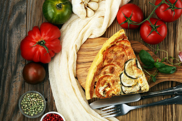 Homemade Cheesy Egg Quiche for Brunch with Spinach and Tomato, onions and zucchini.