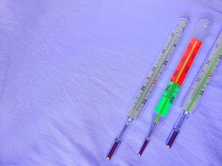 Medicine Medical Health Care Industry Three Thermometers Laying On The Clear Soft Light Blue Background With Copy Paste Text Space 