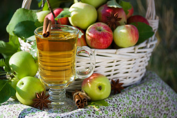 Basket with apples cider juice or vinegar in glass