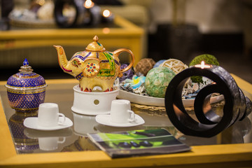Thai interior details of spa, candles on table and kettle with tea