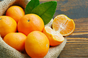 Nutritional Value of a Clementine.
A lot of Clementines,orange or citrus in sack bag on wooden...