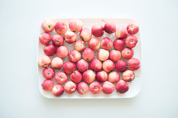 Harvested crop. Ripe red apples on a white background.