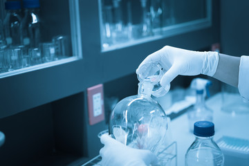 Scientist mix chemicals with The shake machine Before the experiment.Mixture laced with samples into test tubes,Thailand scientist working in the lab