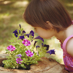 Young girl enjoying the smell of flowers