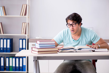 Young handsome student preparing for school exams