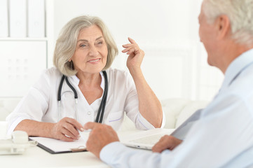 Portrait of senior doctor talk with elderly patient