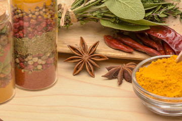 Various spices on wooden background.