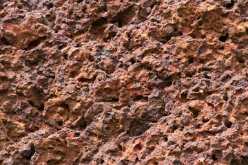background of red laterite stone wall texture