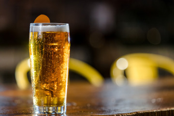 A Cold Glass Of Beer Sitting On A Wood Bar Table
