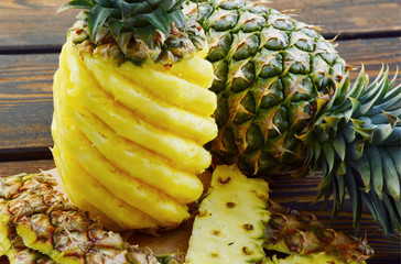 Ananas or Pineapple on wooden background.
way to peel and cut a pineapple. 