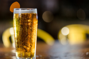 A Cold Glass Of Beer Sitting On A Wood Bar Table