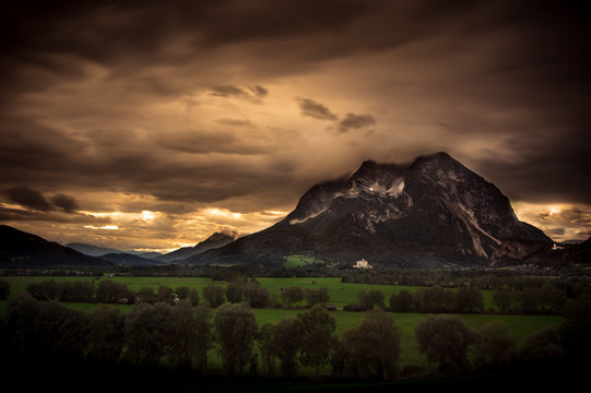 a dramatic sunset behind the mountain Grimming