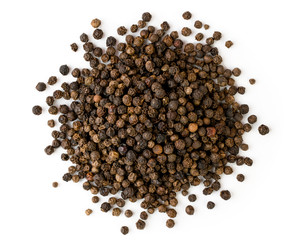 Pile of black pepper close up on a white. The view from the top.