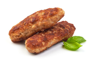 Fried long pork cutlets with basil leaves, isolated on white background.