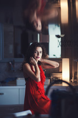 Obraz na płótnie Canvas Beautiful sexy brunette woman in red dress indoor