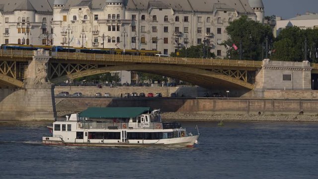 Pest-Buda boat in Budapest on the Danube, floats in front of the Margit bridge - stabilized Cinelike-D