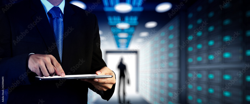 Poster Businessman working with VR wide blank screen computer on server room in background.