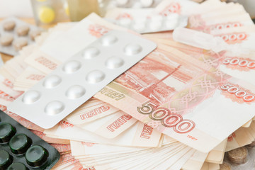 Pills and drugs with large Russian money lie on the table