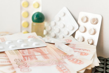 Pills and drugs with large Russian money lie on the table