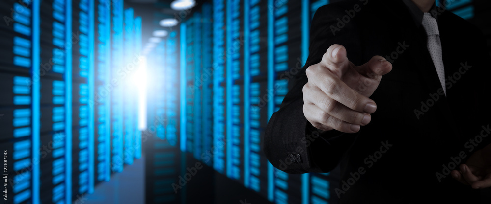 Poster Businessman working with VR wide blank screen computer on server room in background.