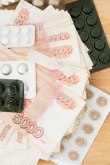 Pills and drugs with large Russian money lie on the table