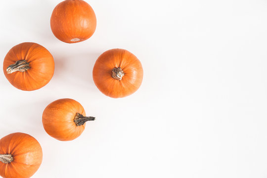 Autumn composition. Pumpkins on white background. Autumn, fall, halloween concept. Flat lay, top view, copy space