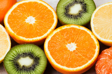  Female hands holding a lemon, orange, kiwi on a white background
